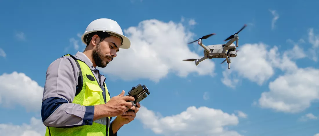 engineer-safety-vest-operating-drone-inspect-survey-electrical-power-lines-technician-inspecting-power-station-scheduled-maintenance
