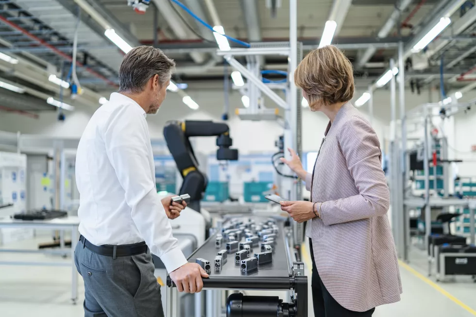 businessman-businesswoman-talking-modern-factory-hall(2)