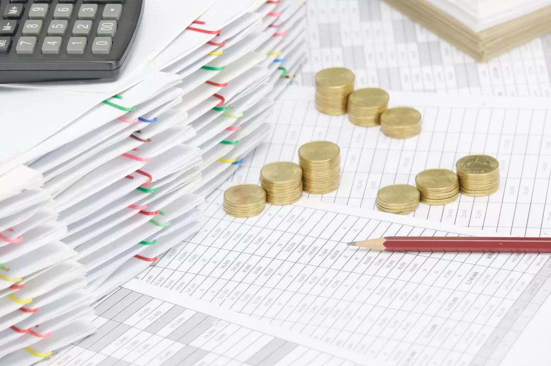 high-angle-view-coins-with-calculator-financial-documents