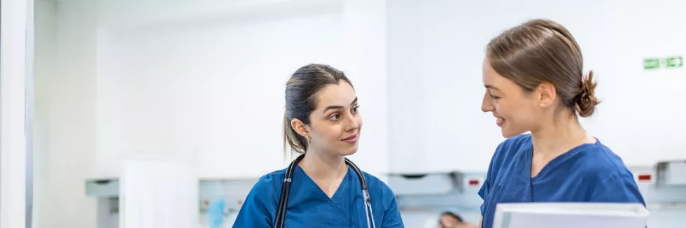 Nursing-Masters-test-two-female-medical-doctors-or-nurses-in-blue-scrubs-looking