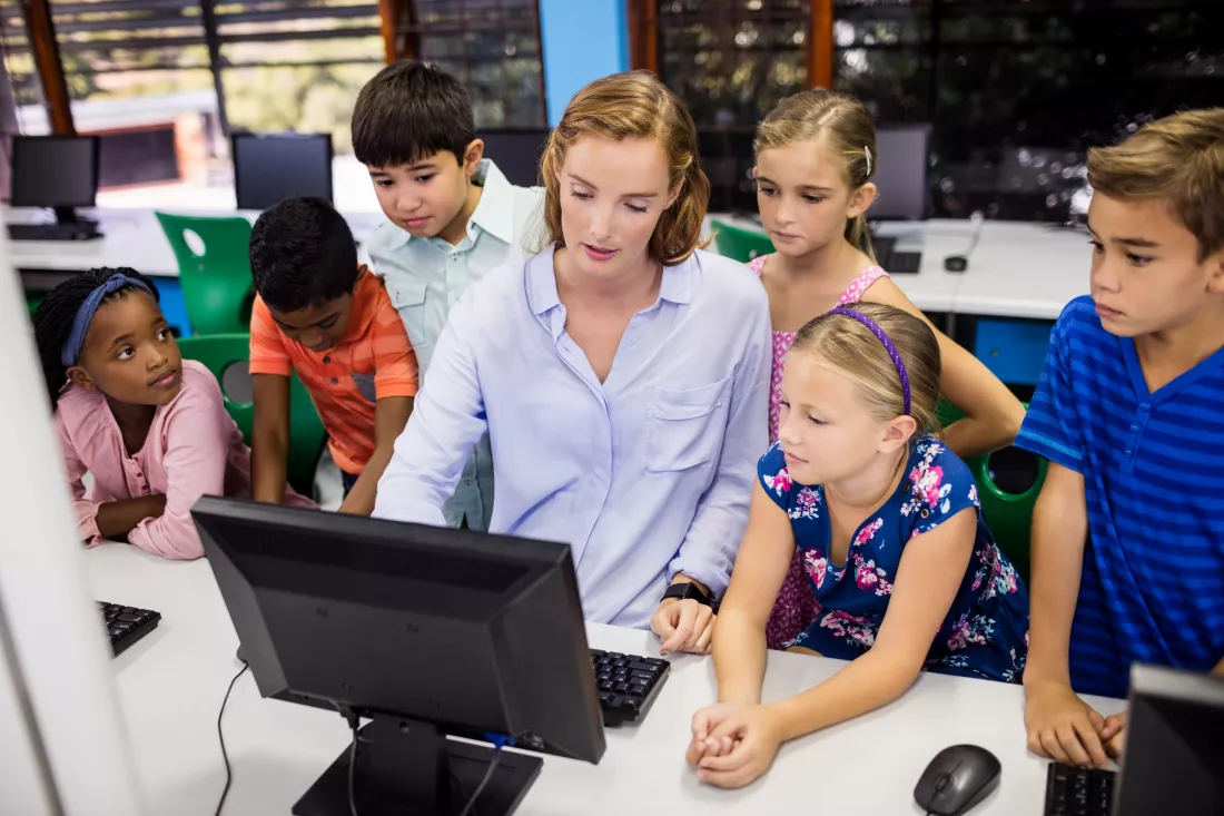 teacher-giving-lesson-her-students-with-computer-pc