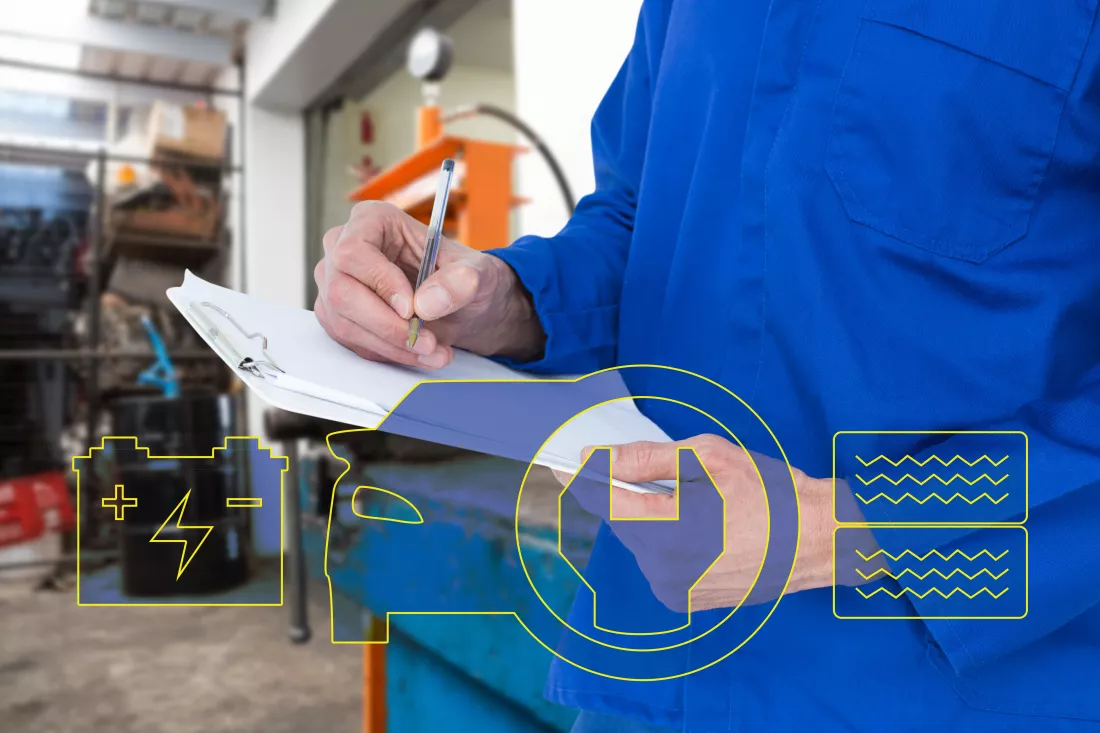 mechanic-writing-notes-clipboard-against-empty-work-station