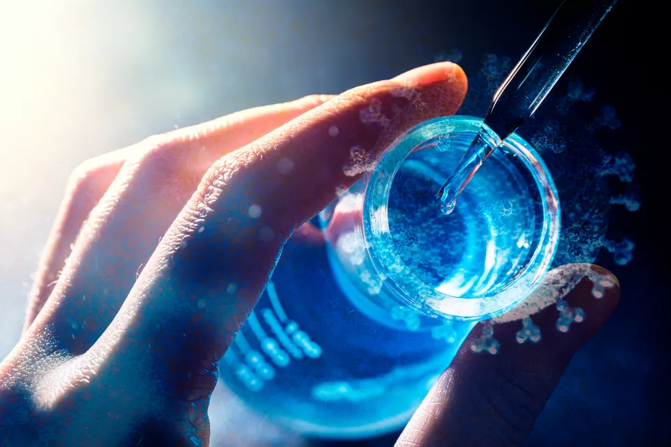 hand-scientist-holding-flask-with-lab-glassware-test-tubes-chemical-laboratory-background