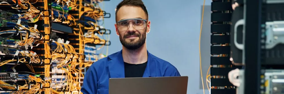 computer-systems-and-network-engineering-with-laptop-in-hands-young-man-is