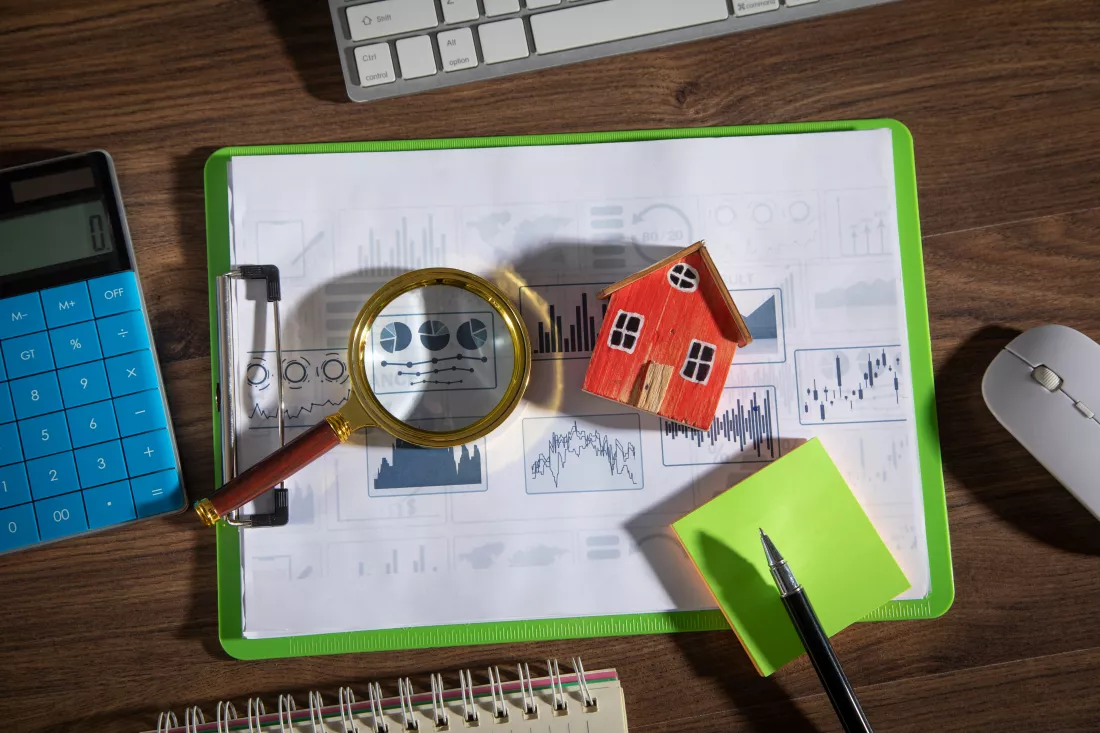 house-model-graphs-magnifying-glass-with-business-objects-table