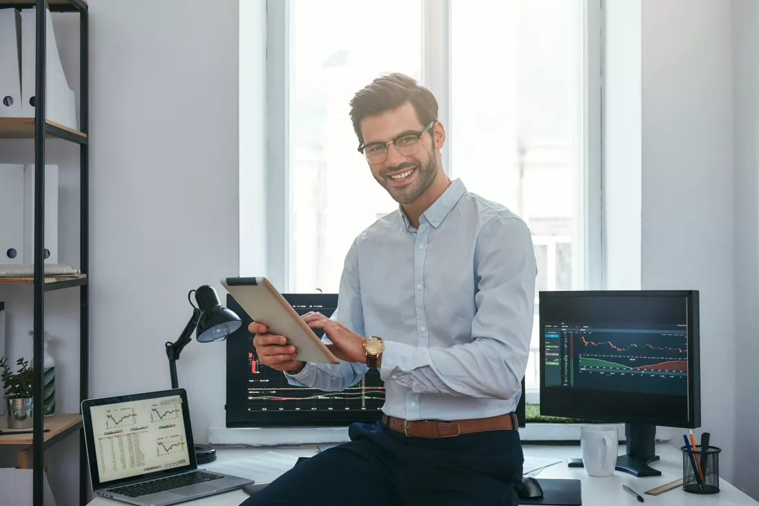 business-success-cheerful-young-trader-formal-wear-is-holding-digital-tablet-looking
