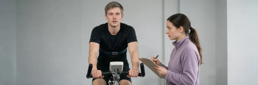 postgraduate-pe-students-running-a-fitness-test-on-an-exercise-bike