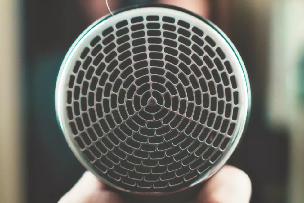 cropped-image-woman-holding-hair-dryer-indoors