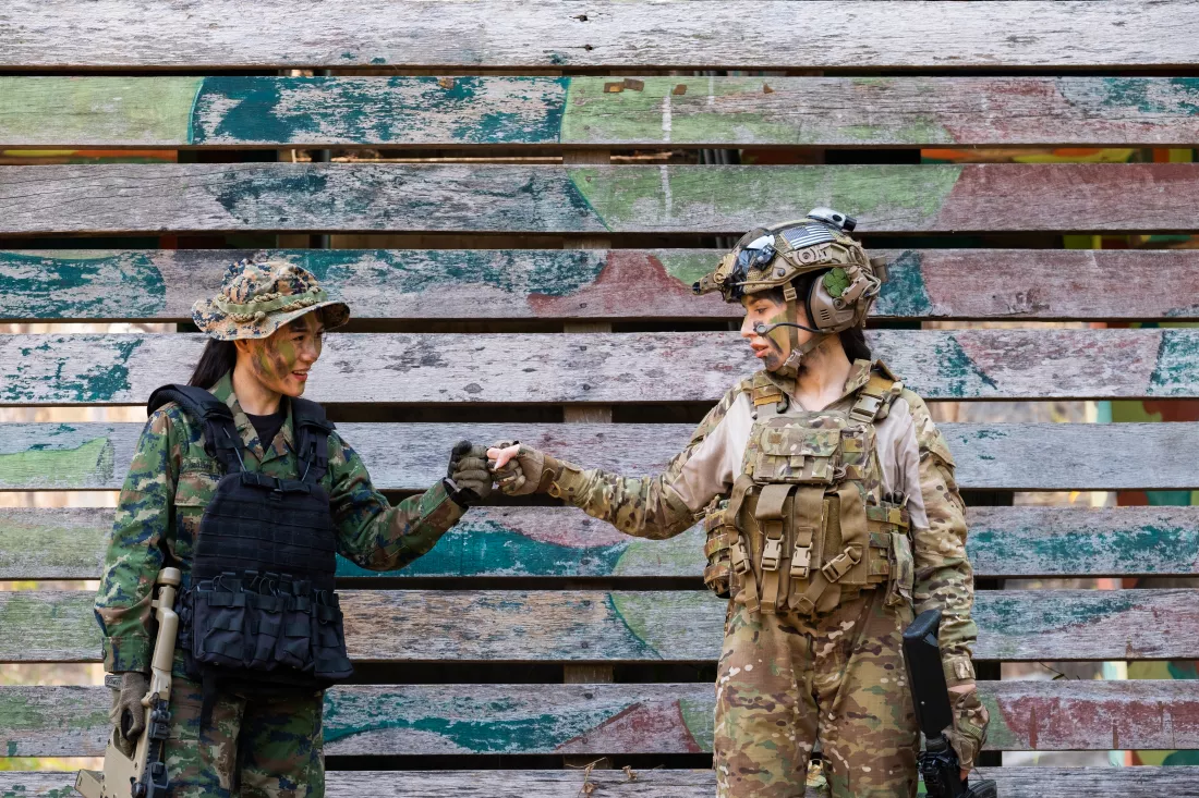 female-army-soldiers-doing-fist-bump-against-wall